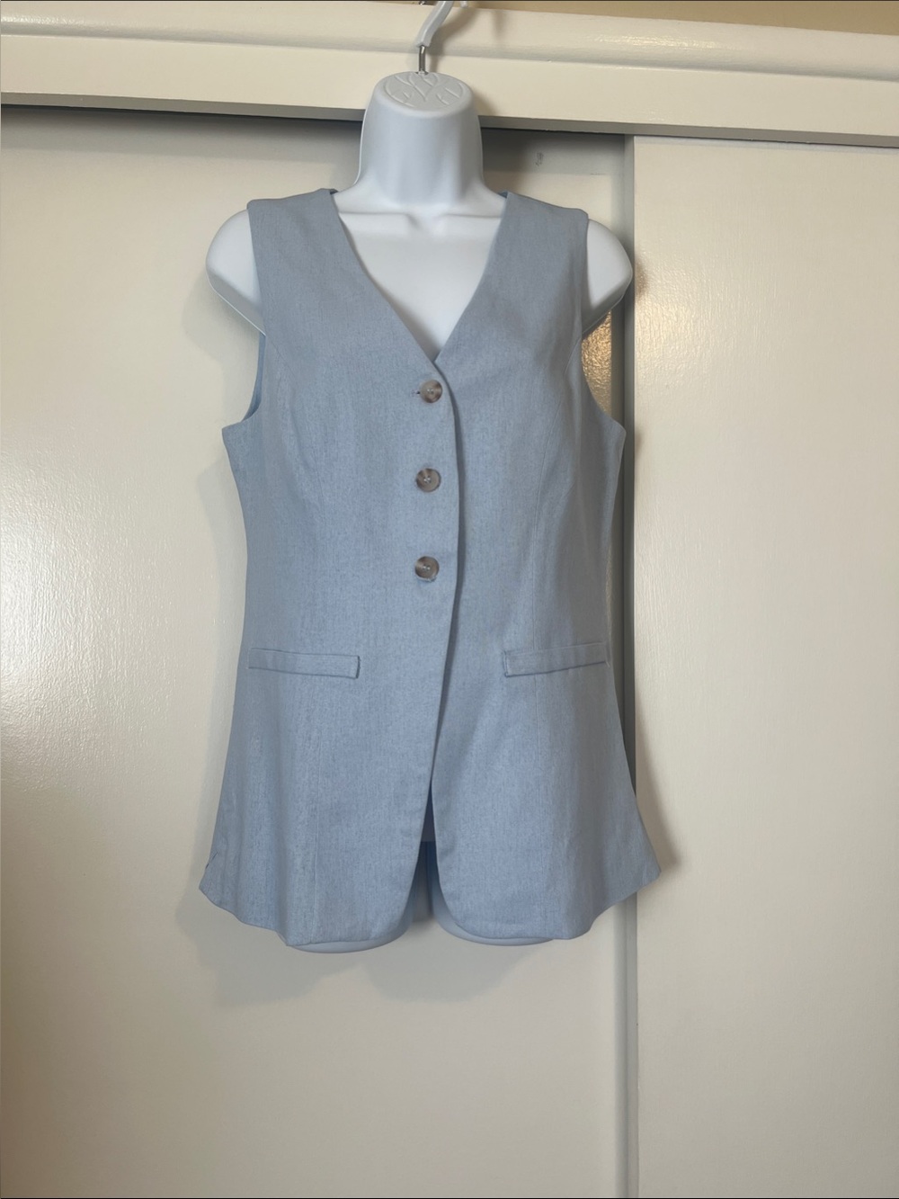 Sleeveless Light Blue Tailored Button-Front Vest.